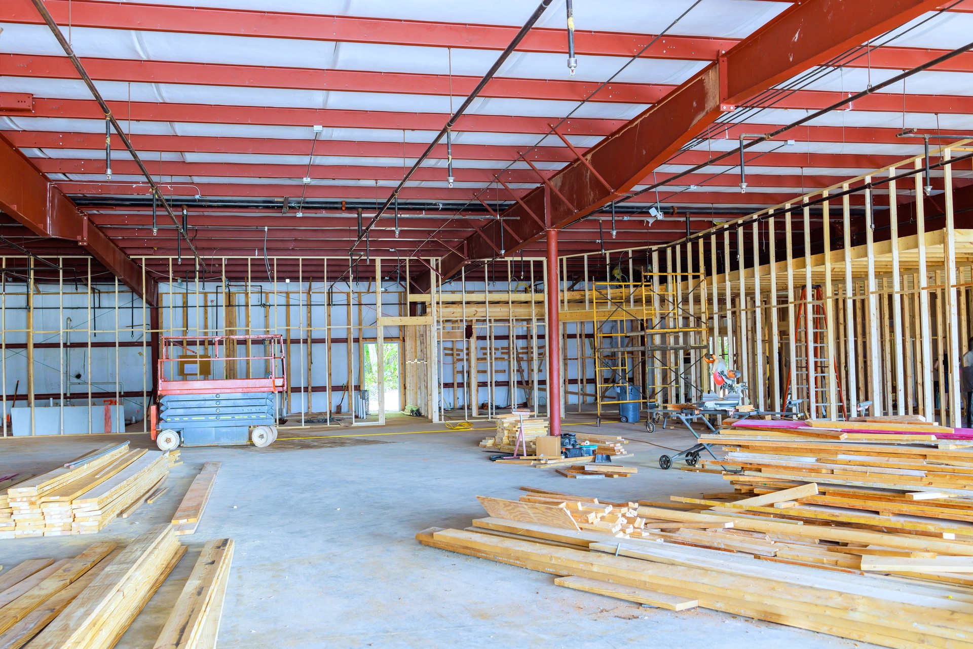 Construction is currently underway in a large room of warehouse to reconstruct interior